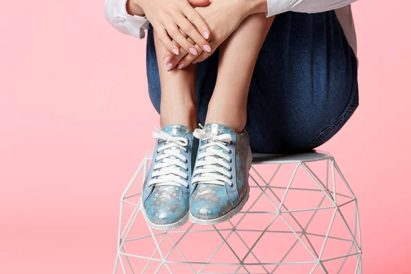 Mujer en zapatos elegantes en el taburete contra el fondo de color, primer plano — Foto de Stock