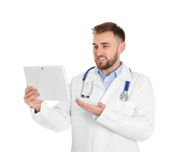 Médico masculino usando bate-papo por vídeo no tablet contra fundo branco — Fotografia de Stock