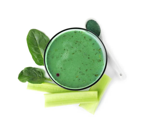 Glas Spirulina smoothie, poeder, spinazie en selderij op witte achtergrond, bovenaanzicht — Stockfoto