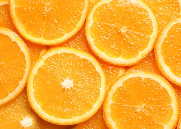 Šťavnaté oranžové řezy jako pozadí, pohled shora. Citrusové plody — Stock fotografie