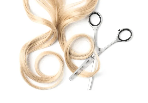 Curly blond hair and thinning scissors on white background, top view. Hairdresser service Stock Image