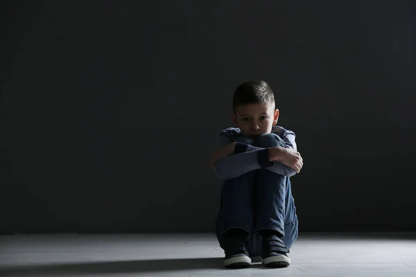 Upset boy sitting in dark room. Space for text — Stock Photo, Image