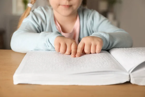 Blind child reading book written in Braille at table, closeup — Stock Photo, Image