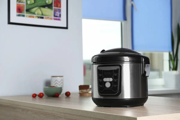 Modern multi cooker and ingredients on table indoors, space for text — Stock Photo, Image