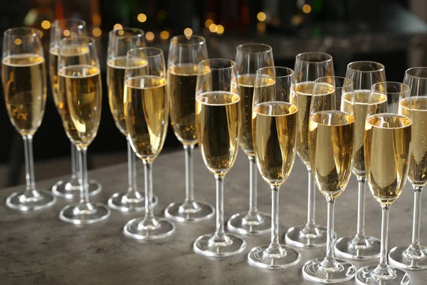 Bulanık arka plana karşı masada şampanya gözlükleri — Stok fotoğraf