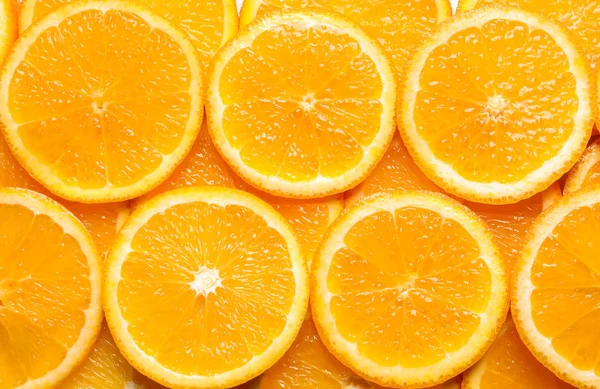 Šťavnaté oranžové řezy jako pozadí, pohled shora. Citrusové plody — Stock fotografie
