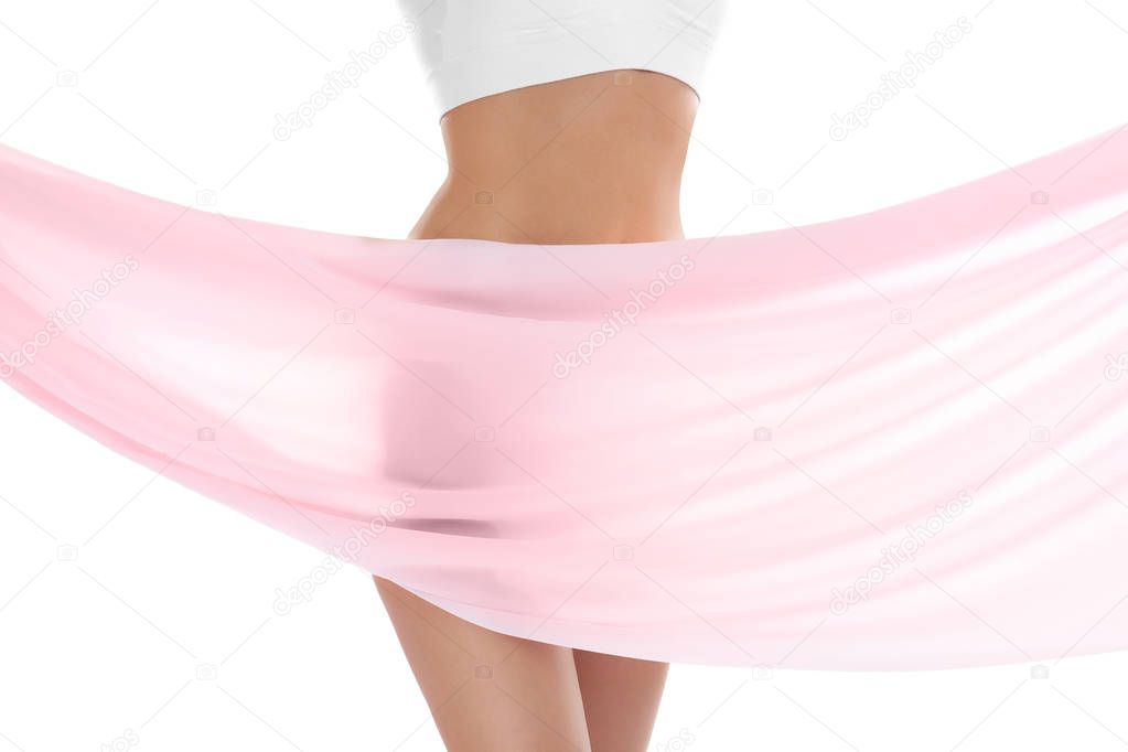 Young woman covering her body with silk fabric on white background. Beauty care