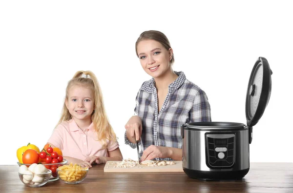 母亲和女儿准备食物与现代多炊具在桌子上的白色背景 — 图库照片