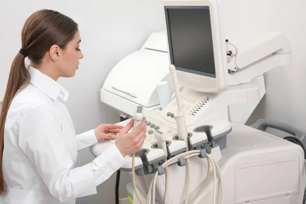 Professionele sonographer met behulp van moderne echografie machine in kliniek — Stockfoto