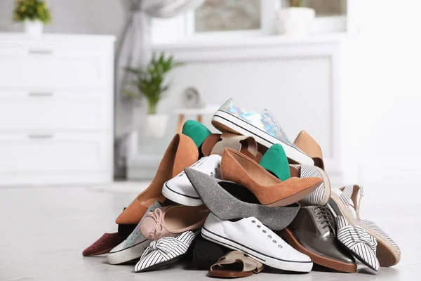 Pile of female shoes on floor indoors — Stock Photo, Image