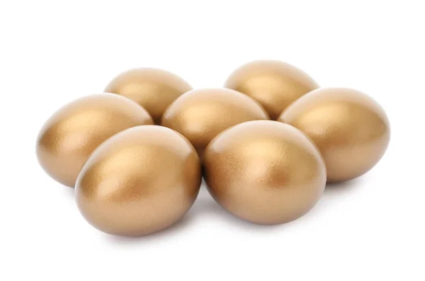 Wiele błyszczących złotych jaj na białym tle — Zdjęcie stockowe