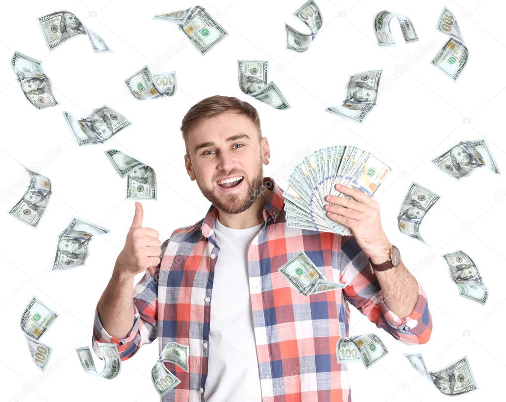 Portrait of happy young man with money and flying American dollars on white background