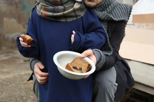 Poor father and child with bread at dump, closeup — Stock Photo, Image