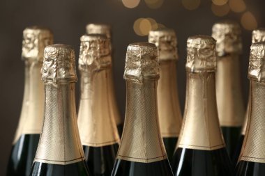 Many bottles of champagne on blurred background, closeup clipart