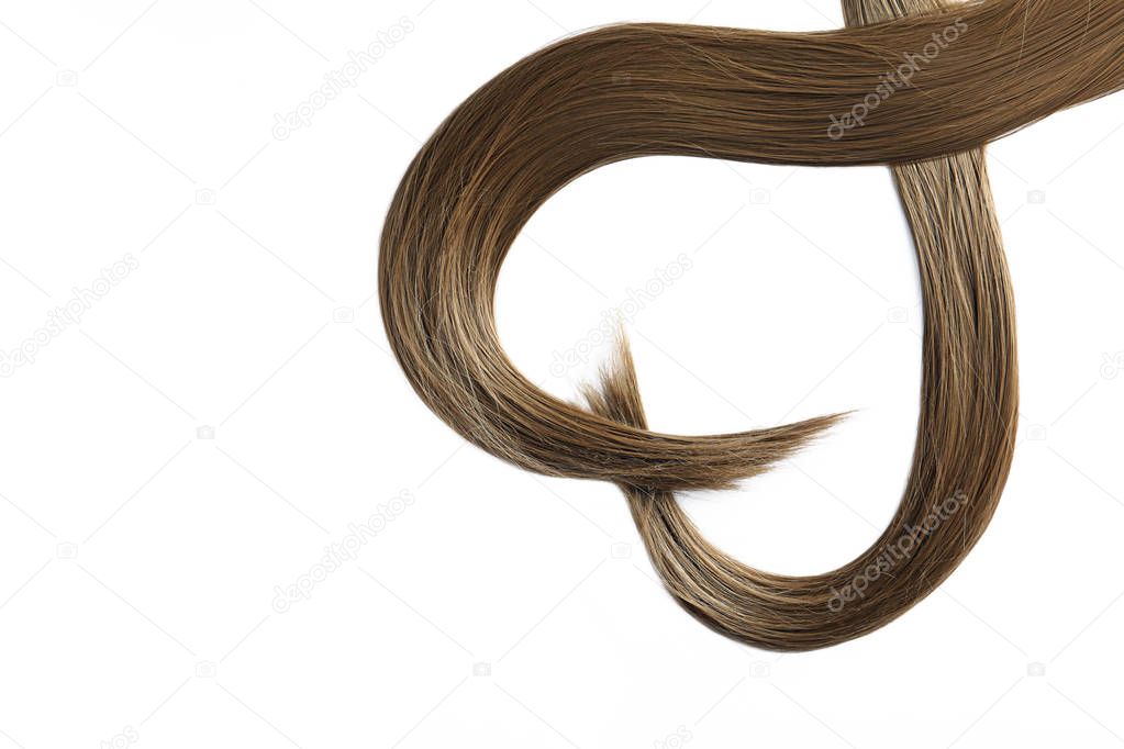 Beautiful strands of brown hair on white background, top view. Hairdresser service