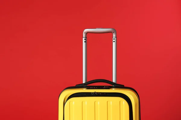 Stylowa żółta walizka z uchwytem na kolorowym tle — Zdjęcie stockowe