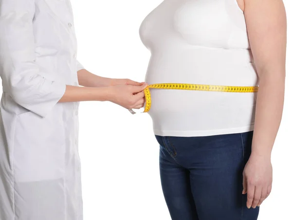 Doctor measuring waist of overweight woman isolated on white, closeup — Stock Photo, Image