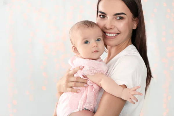 Ritratto di madre felice con il suo bambino contro luci sfocate. Spazio per testo — Foto Stock