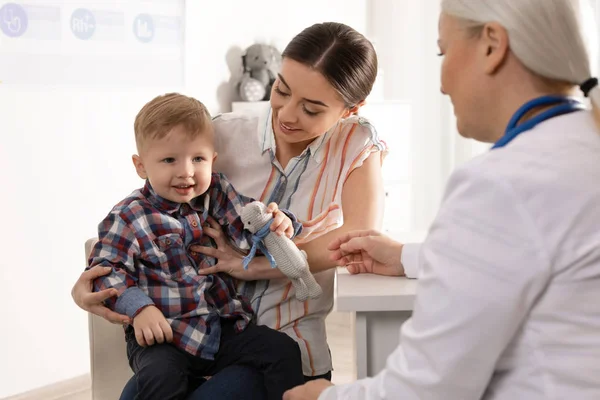 Mother with child visiting doctor in hospital