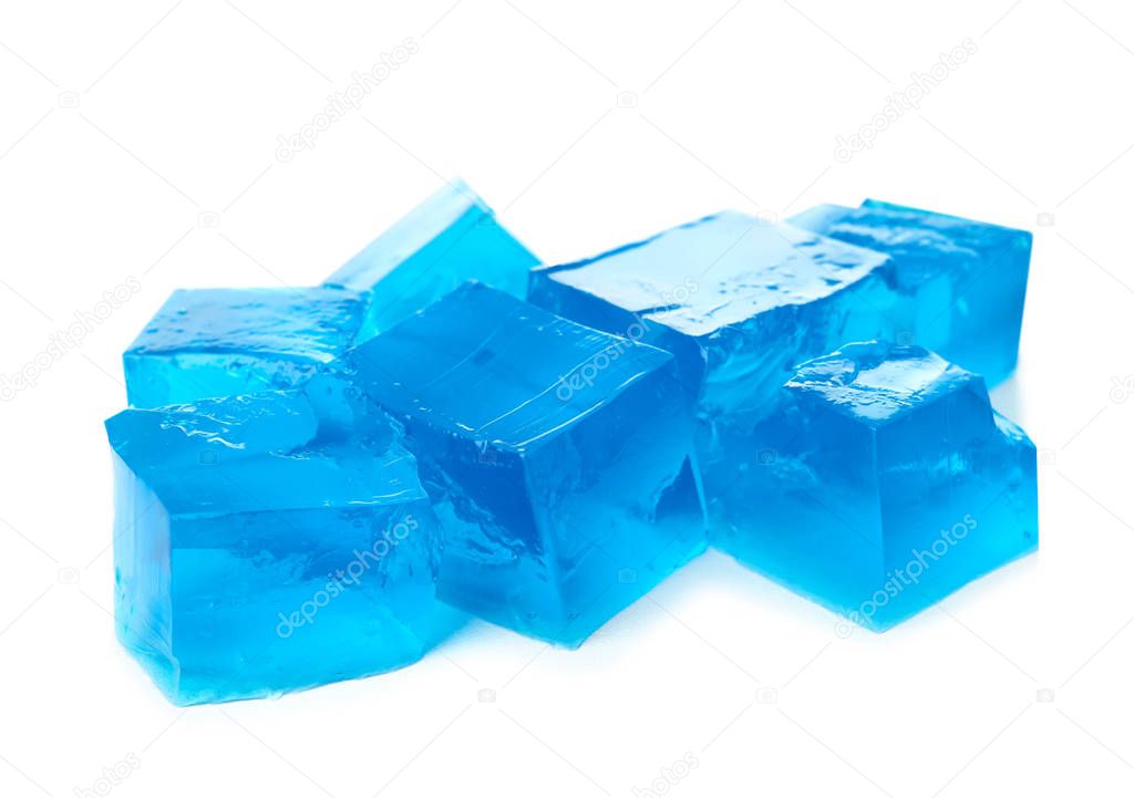 Heap of blue jelly cubes on white background