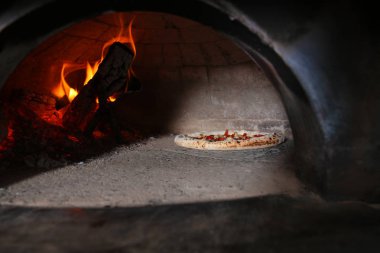 Restoran mutfakta fırında yanan odun ve lezzetli pizza