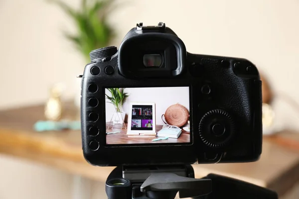 Camera with photo of stylish workplace on screen indoors, selective focus. Fashion blogger — Stock Photo, Image