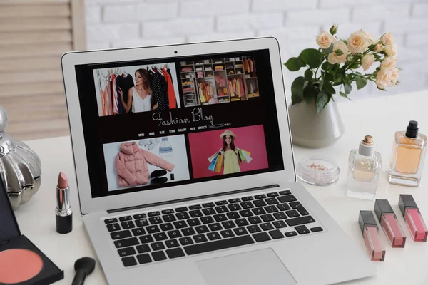 Ноутбук с открытым блоггером моды сайт на столе — стоковое фото