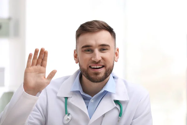 Männlicher Arzt mit Videochat am Arbeitsplatz, Blick aus Kameraperspektive — Stockfoto