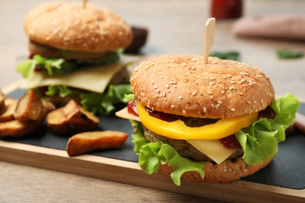 Junta con deliciosa hamburguesa en la mesa. Espacio para texto —  Fotos de Stock