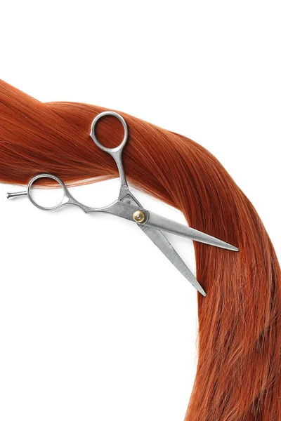 Red hair and scissors on white background, top view. Hairdresser service — Stock Photo, Image