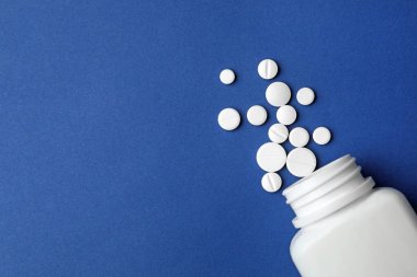 Renkli arka planda farklı haplar ile Şişe, düz yatıyordu. Metin için alan