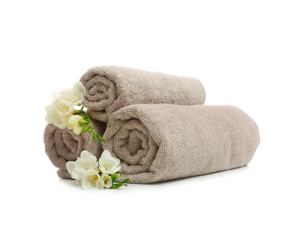 Clean rolled towels with flowers on white background — Stock Photo, Image