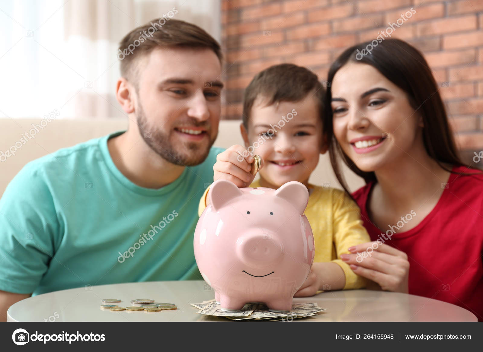 Happy family with piggy bank and money at home Stock Photo by