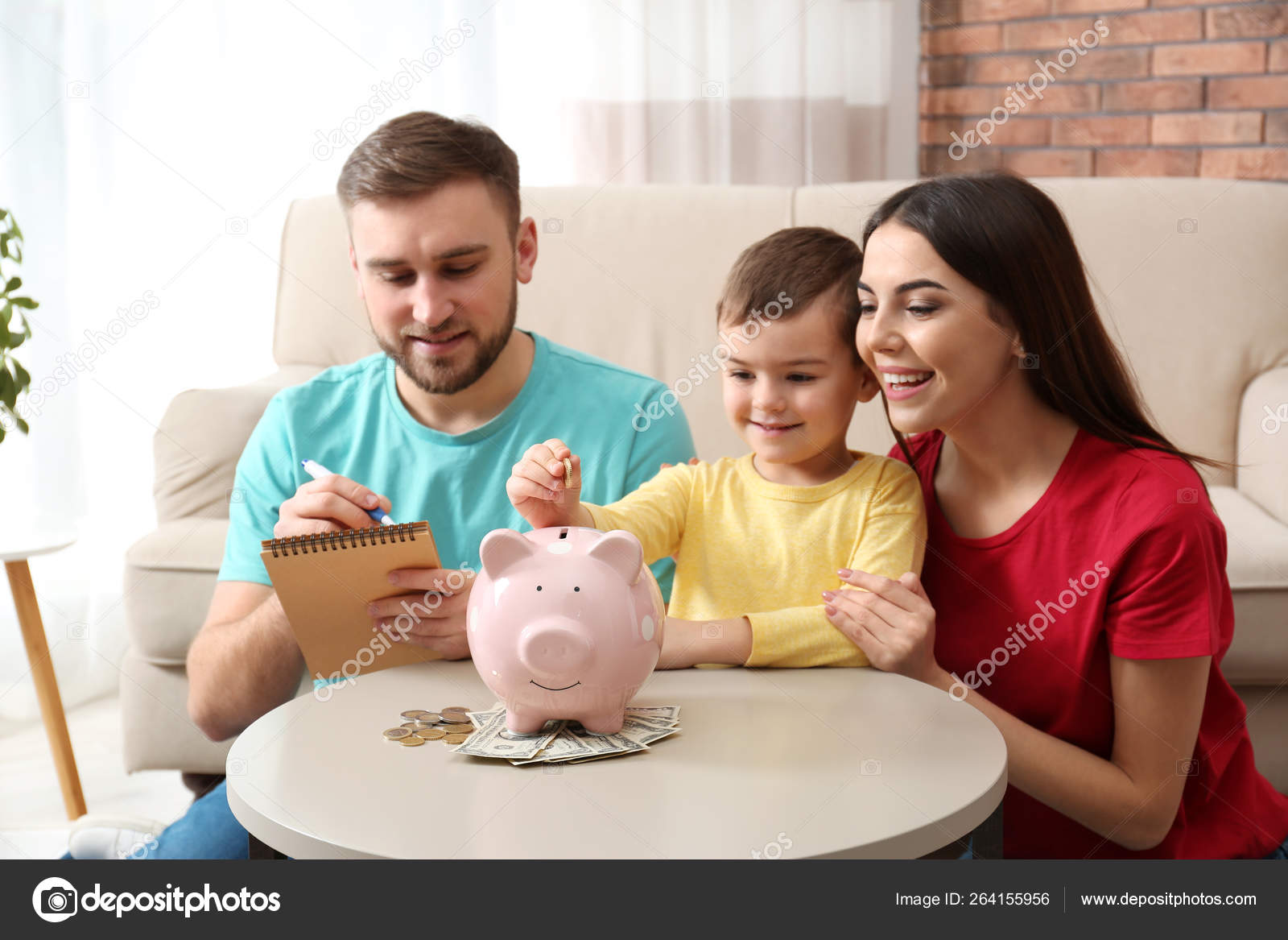 Happy family with piggy bank and money at home Stock Photo by