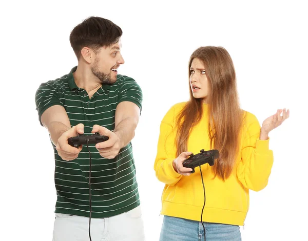 Emotional couple playing video games with controllers isolated on white — Stock Photo, Image