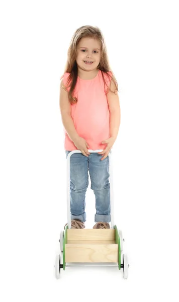 Pretty little girl with wooden cart against white background — Stock Photo, Image