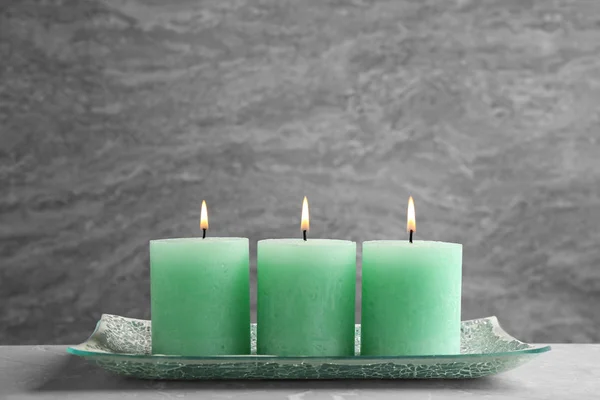 Composition with three burning candles on table. Space for text — Stock Photo, Image