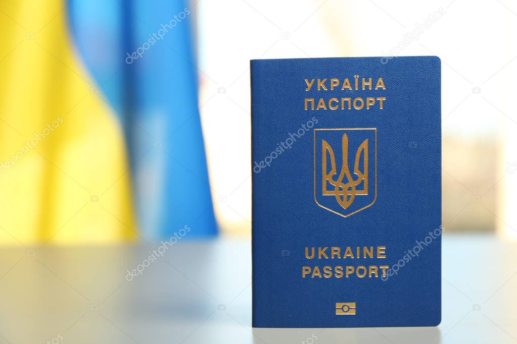 Ukrainian travel passport on table against blurred background, space for text. International relationships