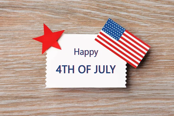 Composición plana con tarjeta de felicitación y bandera de Estados Unidos en mesa de madera. Feliz Día de la Independencia — Foto de Stock