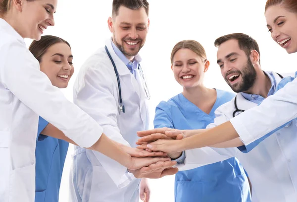 Team of medical doctors putting hands together on white background. Unity concept — Stock Photo, Image