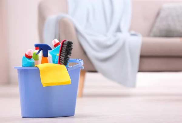 Bucket with cleaning supplies on floor indoors. Space for text — Stock Photo, Image