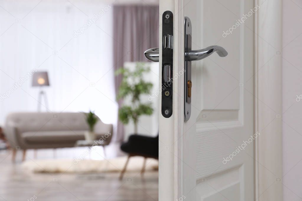 Closeup of open door in modern apartment, space for text