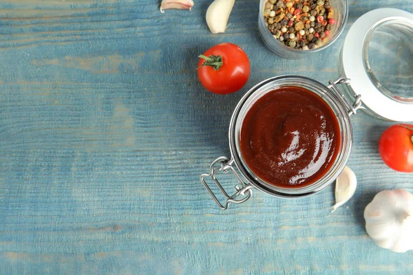 Flat lay composition with barbecue sauce on blue wooden table. Space for text — Stock Photo, Image