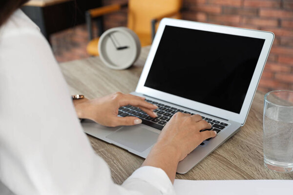 Woman using video chat on laptop in home office, closeup. Space for text