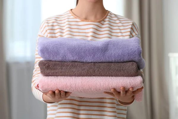 Młoda kobieta trzyma czyste pranie w domu, zbliżenie — Zdjęcie stockowe