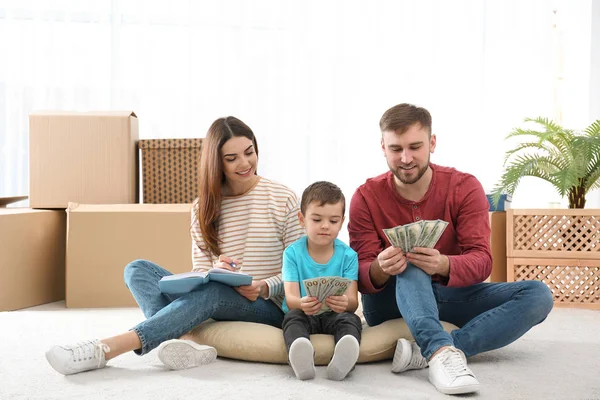 Happy family with money on floor at home — Stock Photo, Image