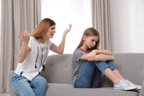 Mother scolding her teenager daughter at home