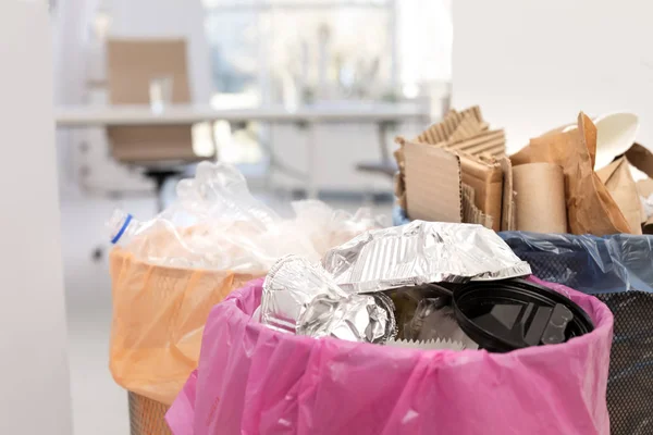 Full trash cans in modern office, closeup. Waste recycling — Stock Photo, Image