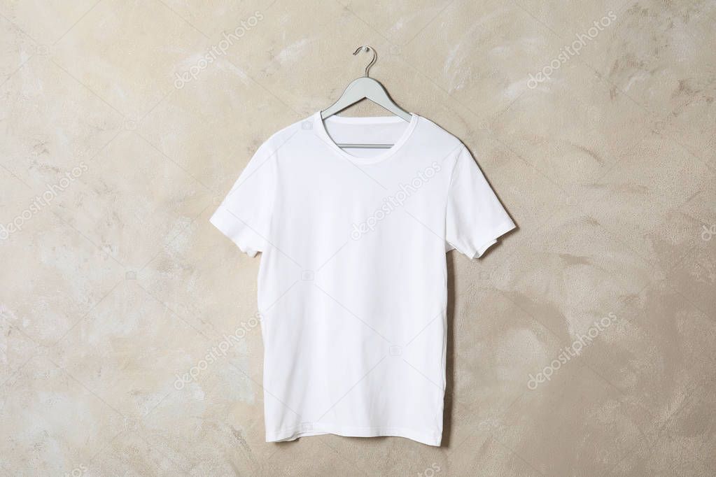 Hanger with white t-shirt on color background. Mockup for design