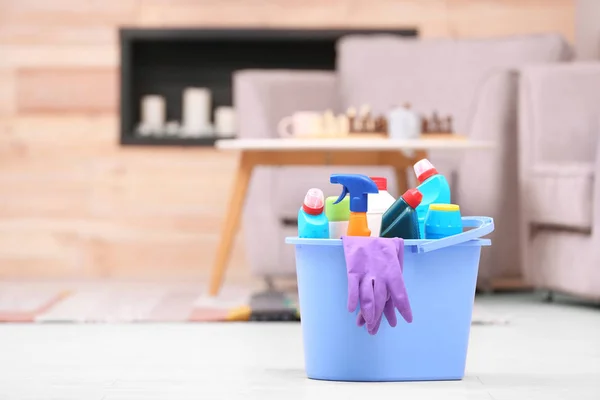 Bucket with cleaning supplies on floor indoors. Space for text — Stock Photo, Image